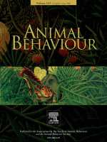 Image of the cover of the Animal Behavior journal which contains a lush green jungle section with a tiger and darker regions of other ecosystems.